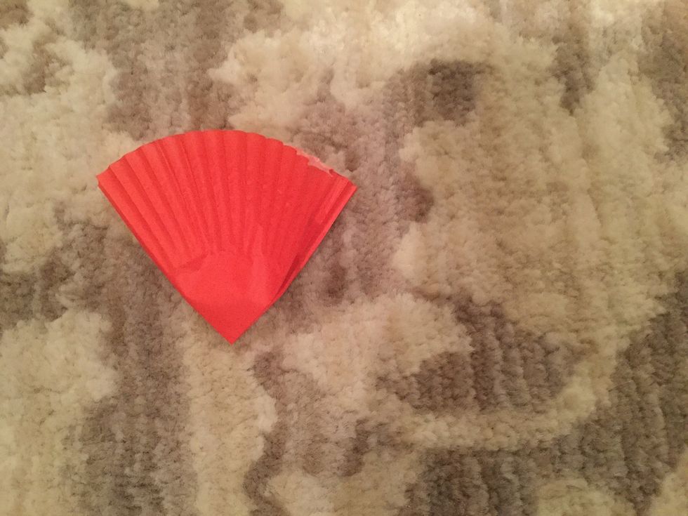 Fold a large cupcake liner in half twice with the folded point at the bottom.