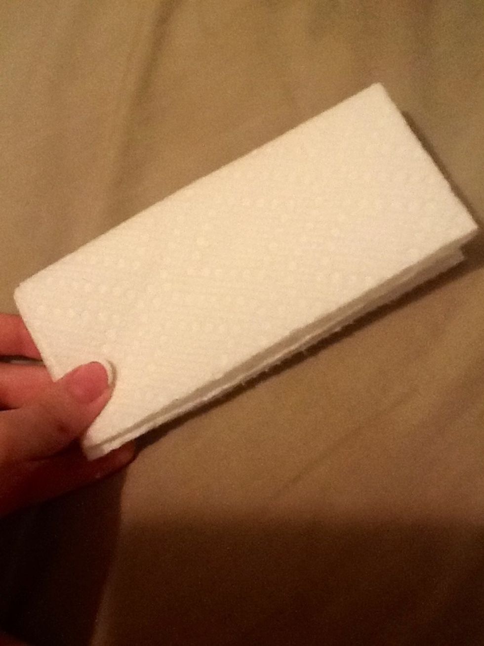 Fold a paper towel like so.. Then soak part of it in nail polish remover and leave another part dry.