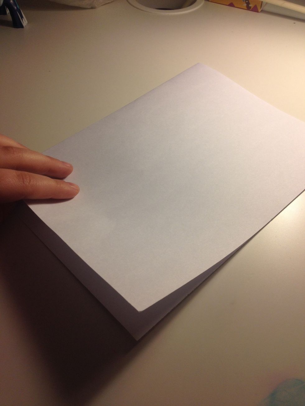 Fold a piece of paper in half (we used A4)