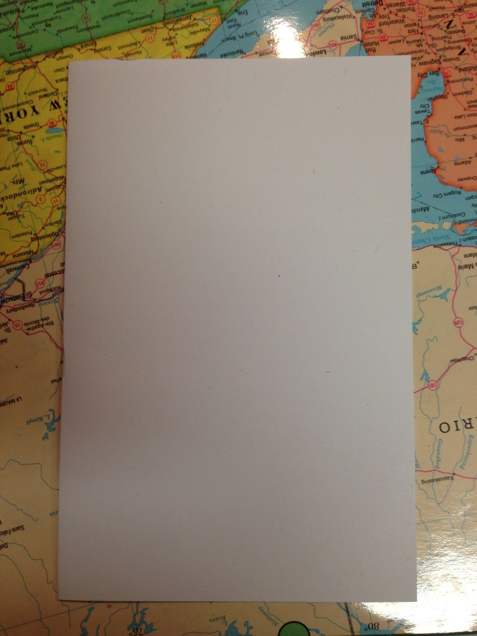 Fold a piece of white 8.5x11 card stock paper in half.