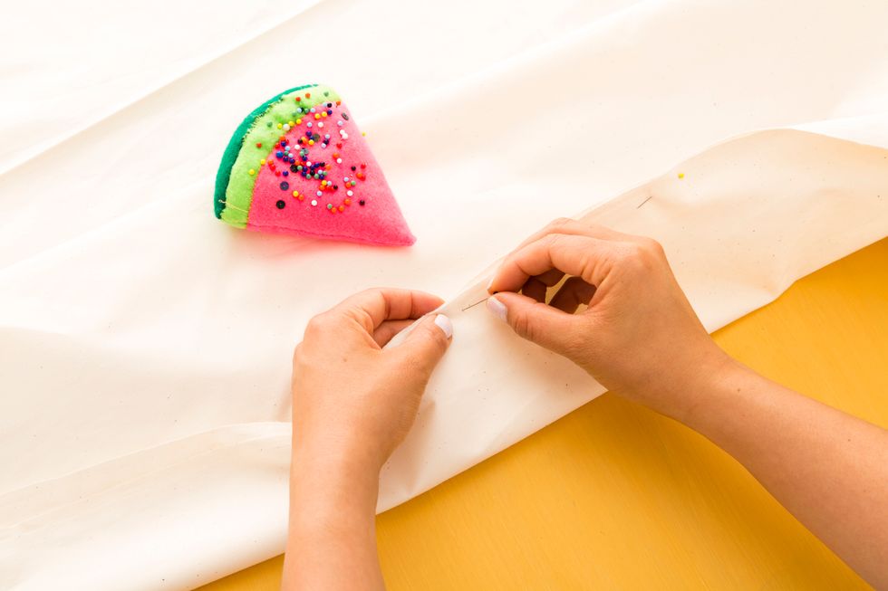 fold a straight line from your mark to the corner of the other end of your long fabric. This will create a diagonal fold lengthwise. Do this to both sides.