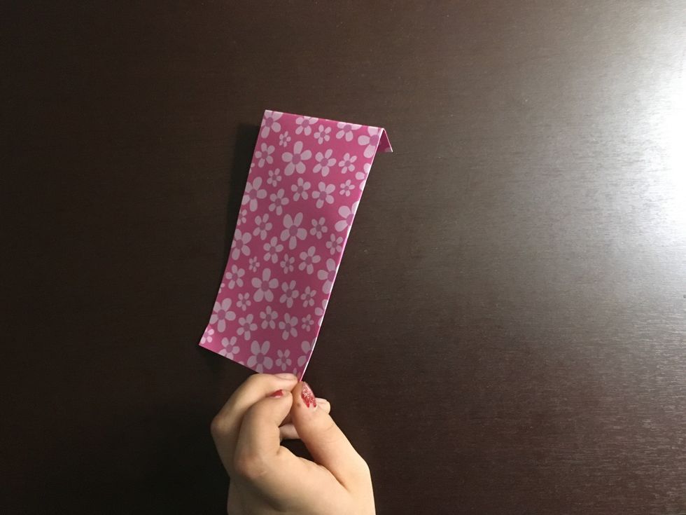 Fold about 1/8 of the paper behind it