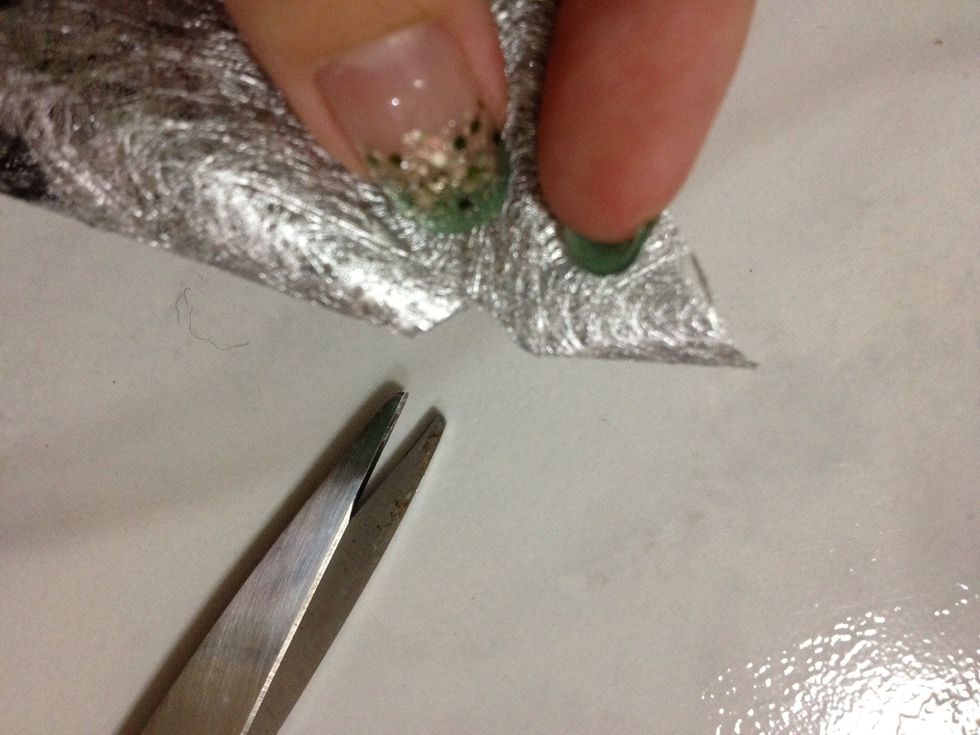 Fold again the top part only and cut a diamond shape