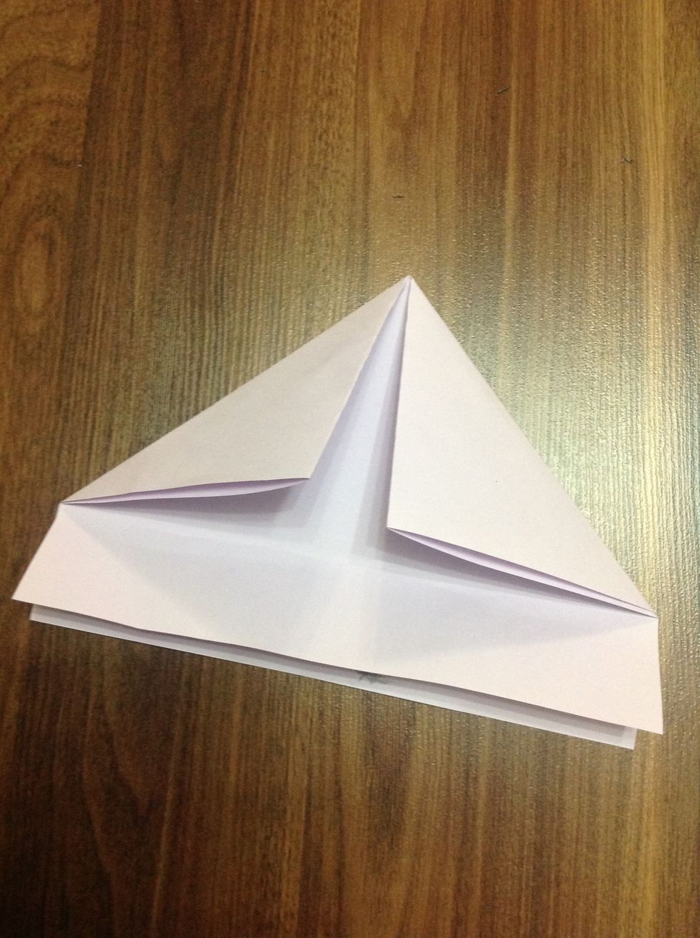 Fold again the two corners of the paper making a triangle look