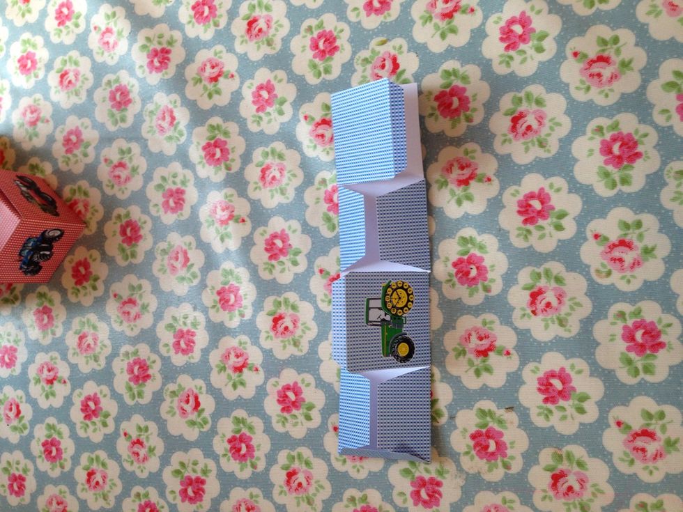 Fold all flaps in towards the centre to make a long strip.