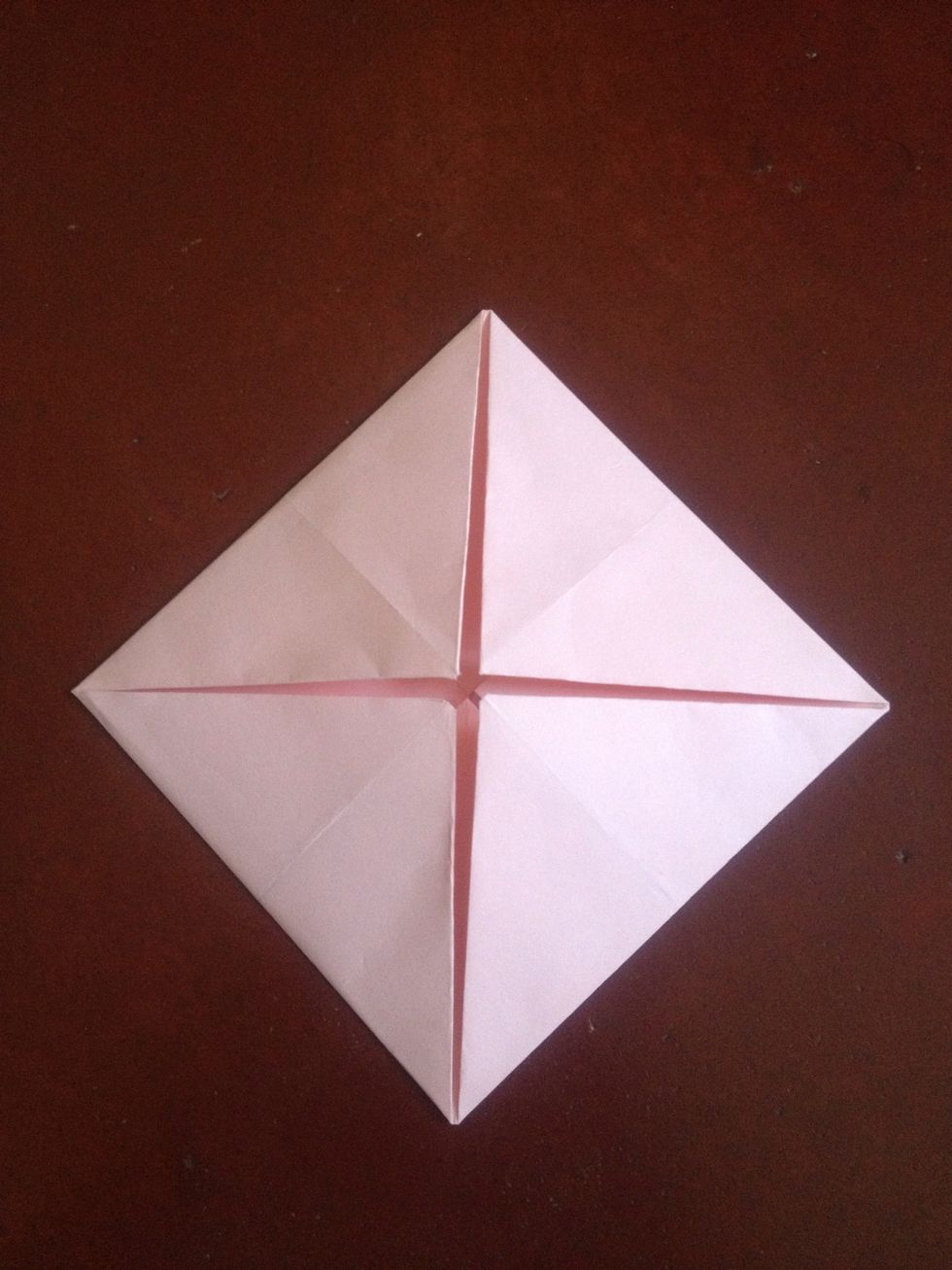 Fold all four corners to the center again..