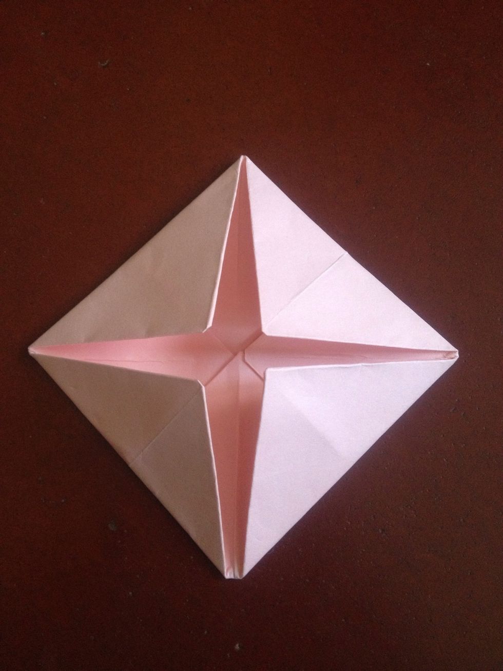 Fold all four corners to the center once more..