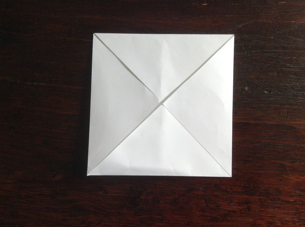 Fold all of the four corners into the middle.