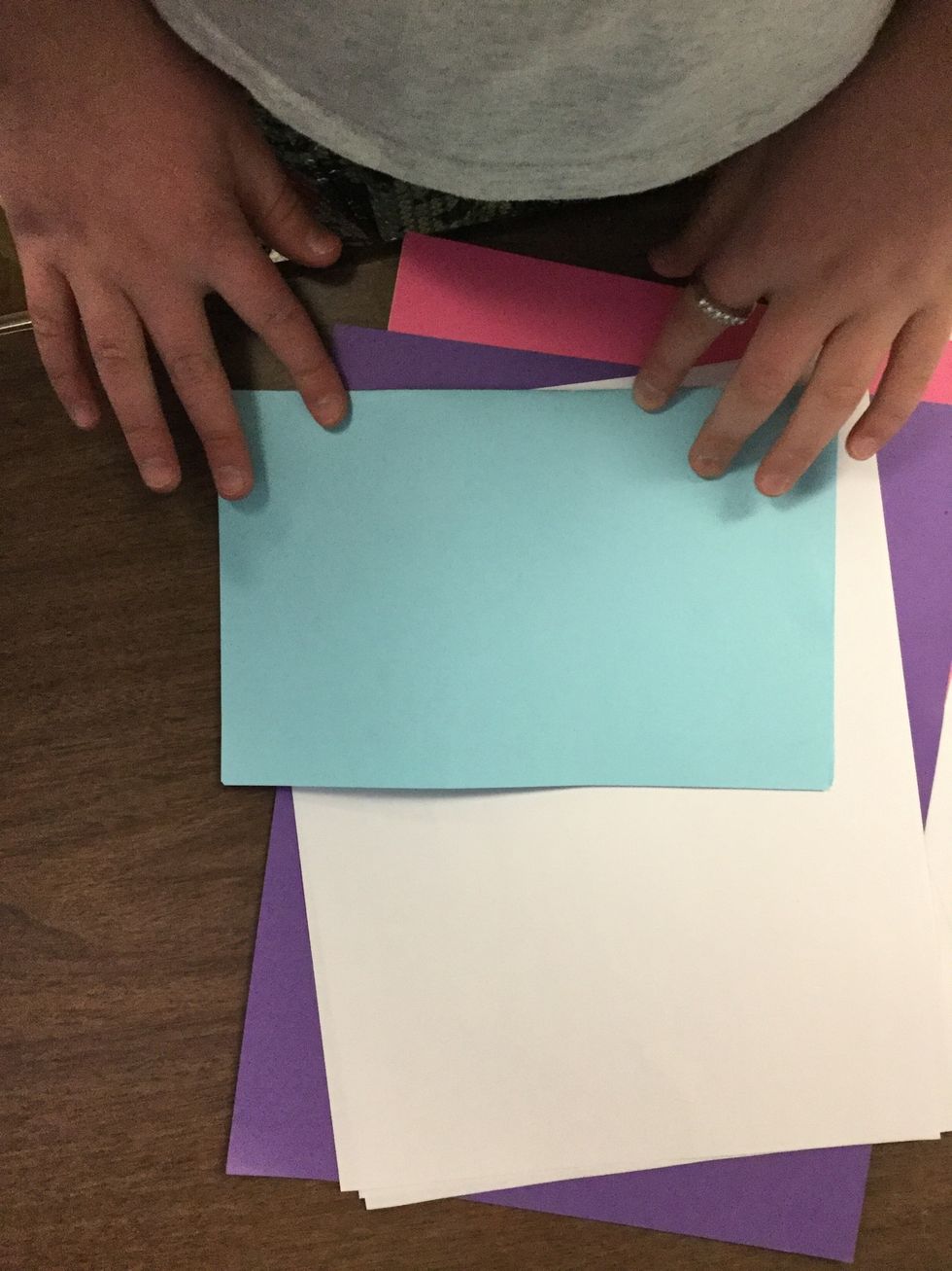 Fold all papers in half with all corners touching