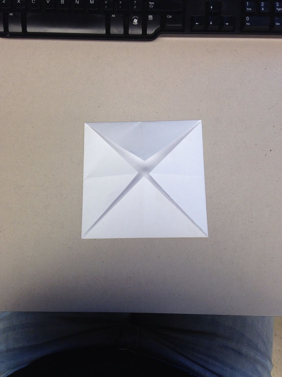 Fold all the corners into the center point.