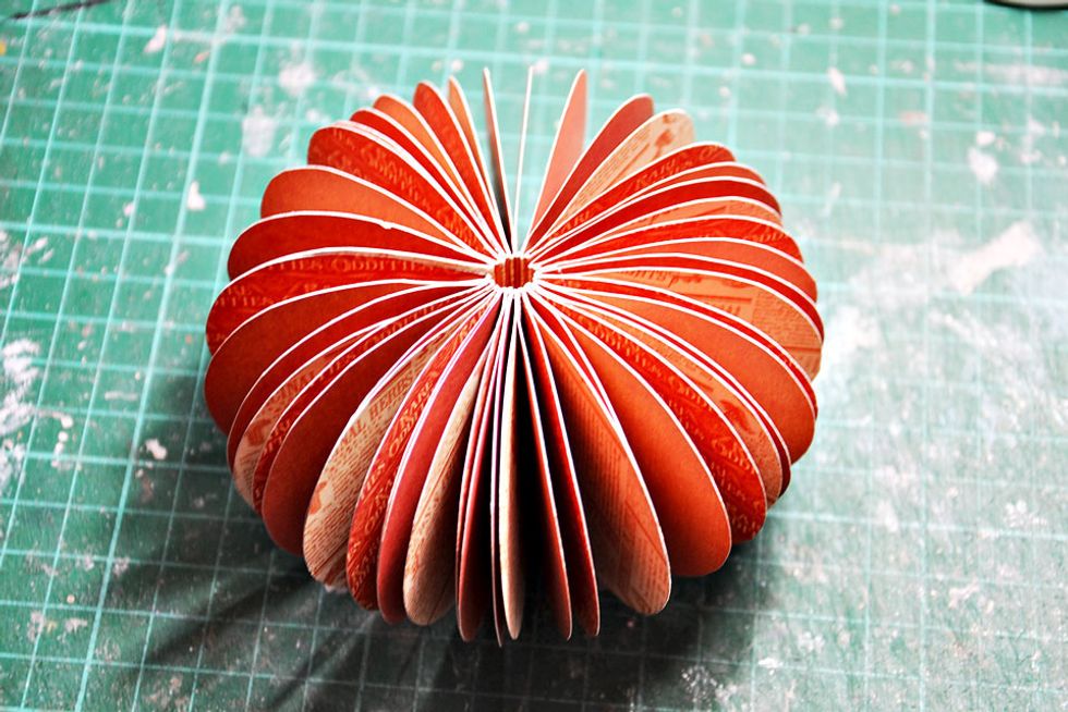 Fold all the way around and glue the two outer pieces together to create the round pumpkin as shown.