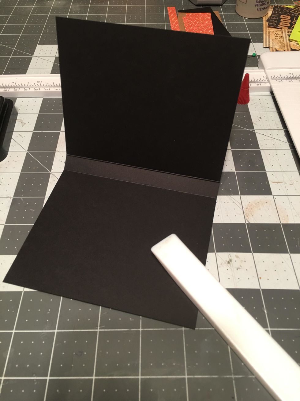 Fold and burnish the center fold lines of the hinge piece so that you have a 1/2" spine in the center.