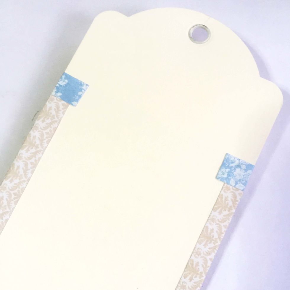 Fold and glue over the flagging tabs onto the interior of the tags. This will give a more polish look on the edges.