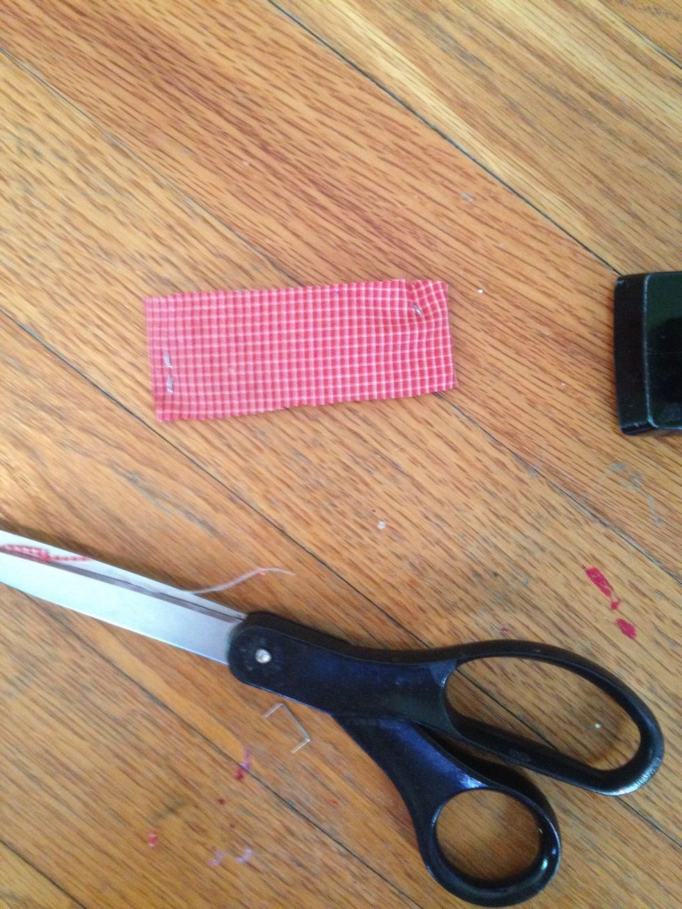 Fold and staple the red fabric around the tape, don't worry about how the back looks. Just be sure the edges are smooth and the front is nice looking