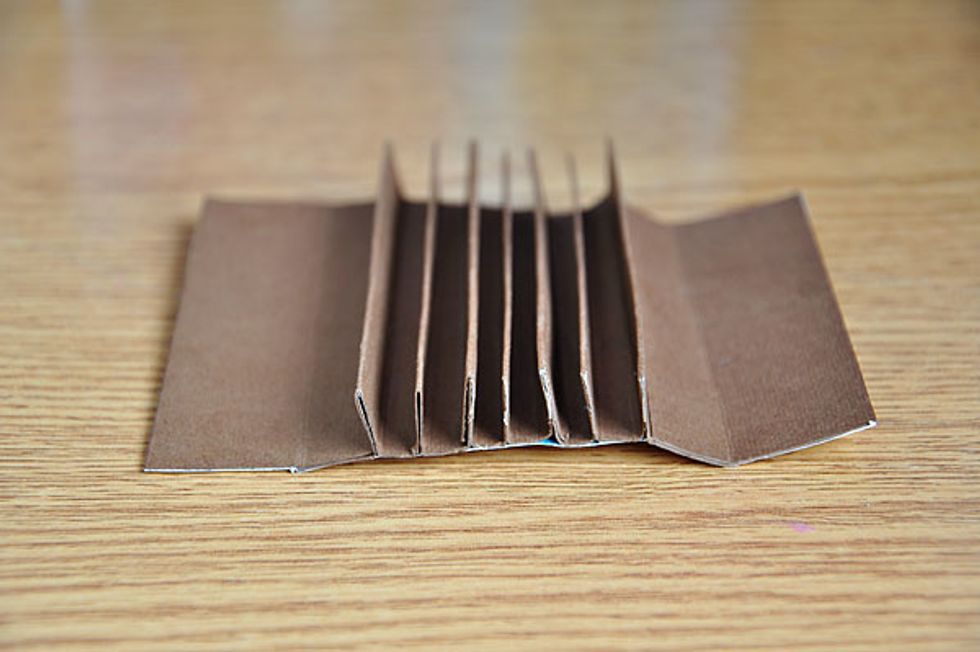 Fold as seen in image. All the bigger spaces will be adhered together, leaving a space of 1/4 in the middle. This will take up to 7 single pages.