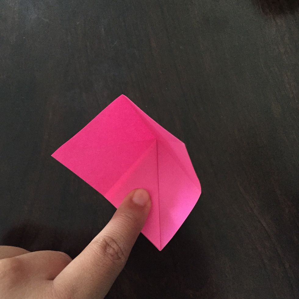 Fold back along the crease that creates this triangle.