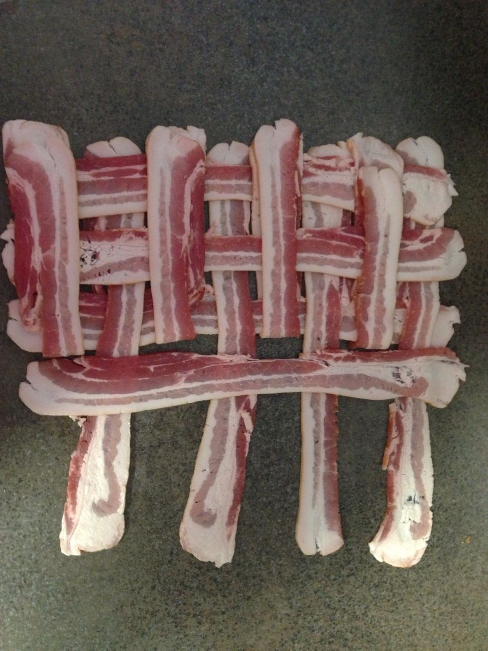 Fold back every other piece and lay a strip of bacon going the opposite direction of your foundational strips.