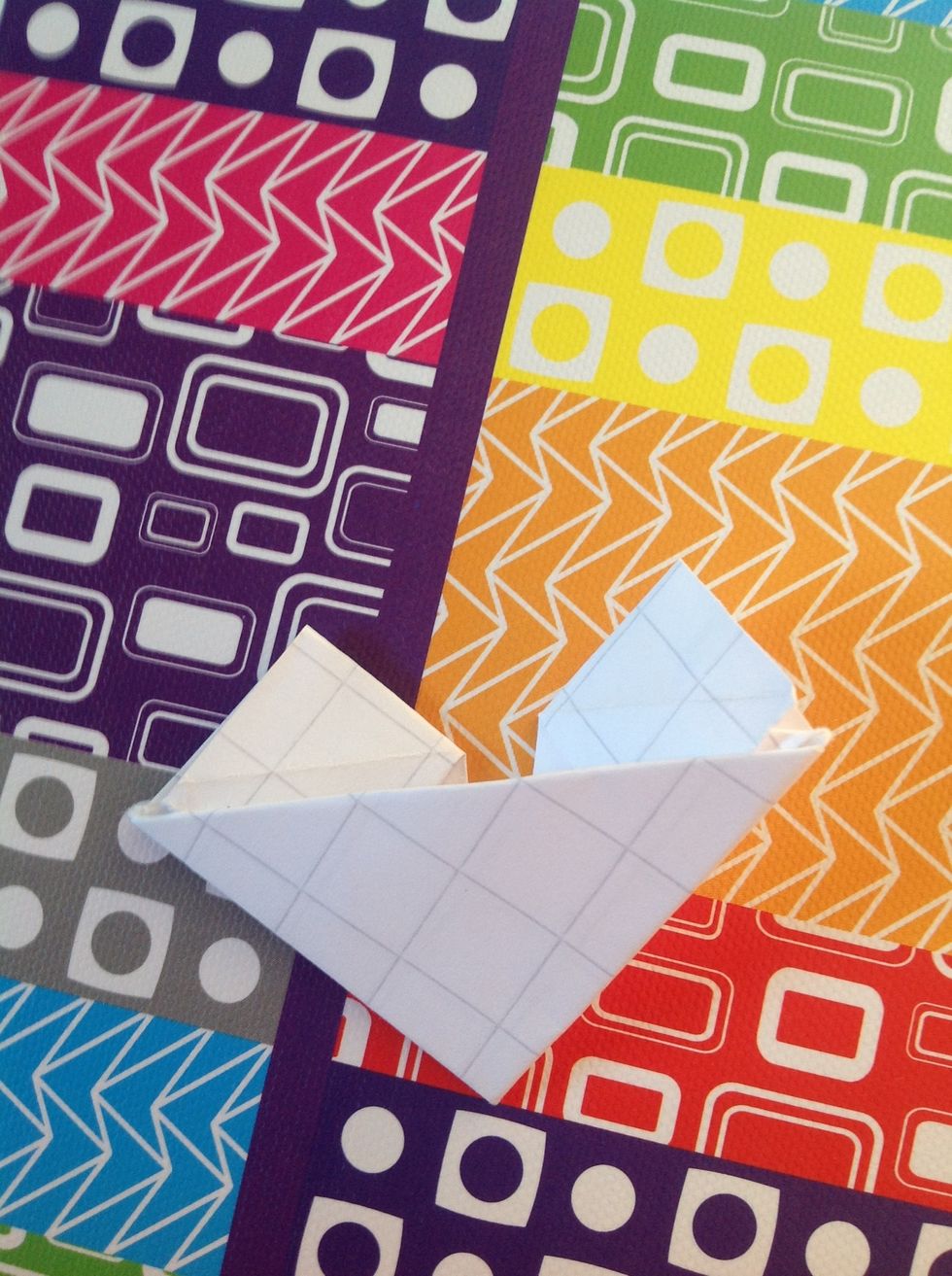 Fold back,keep half the square inside the fold they should look like triangles