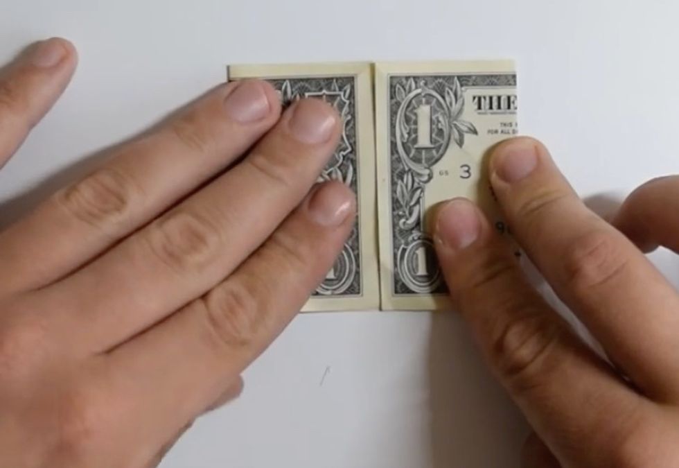 Fold bill into fourths by folding both halves in half
