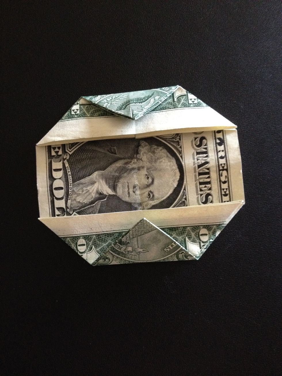 Fold both ends (tips) of the triangles into the center of the bill.