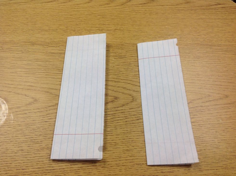 Fold both sheets of paper in half.