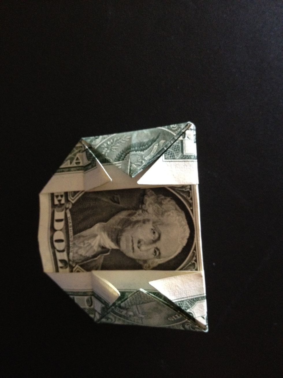 Fold both sides towards the back of the bill - here you see the right side folded (looks like it disappeared).