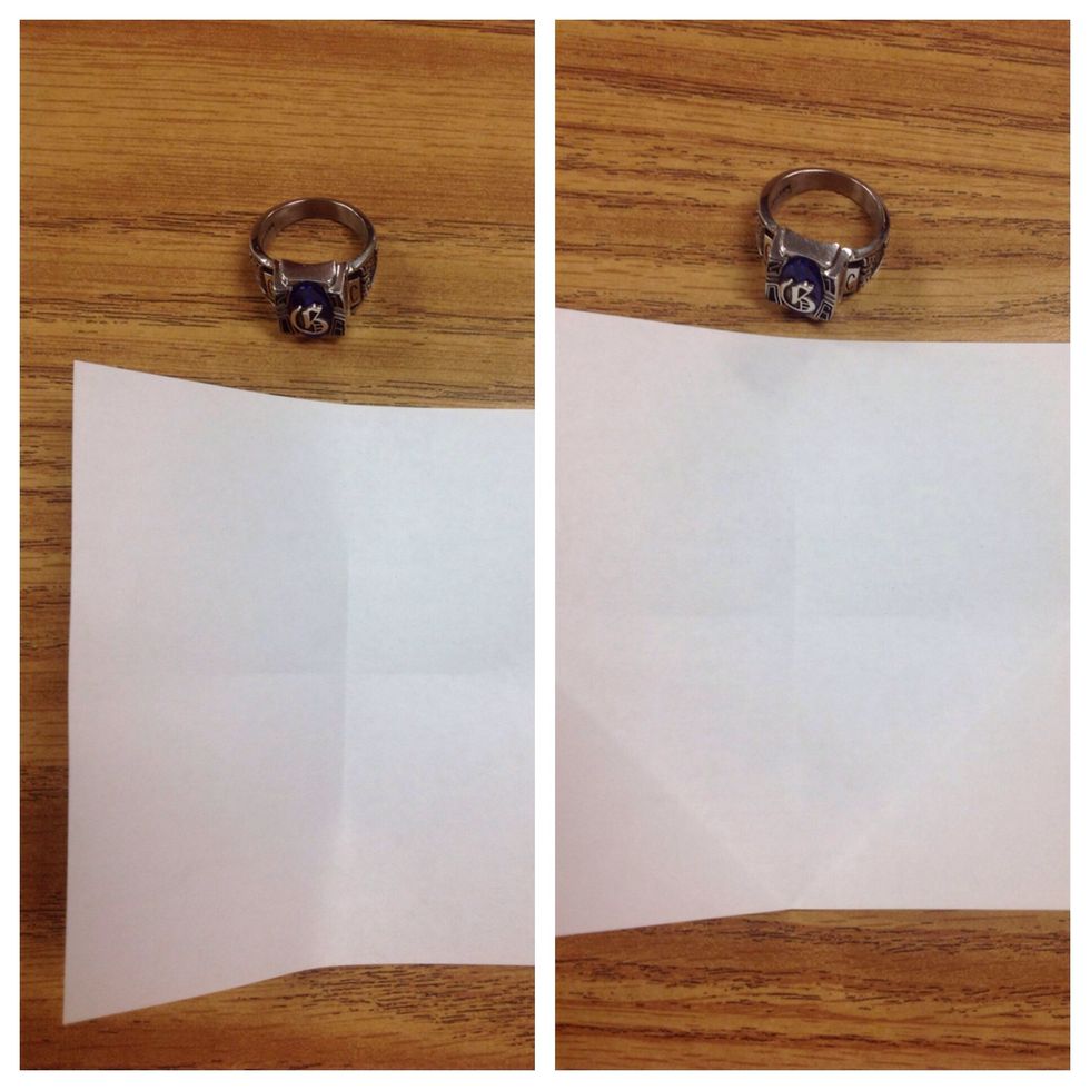 Fold both the bottom right and left tips to the center. Crease well and unfold.