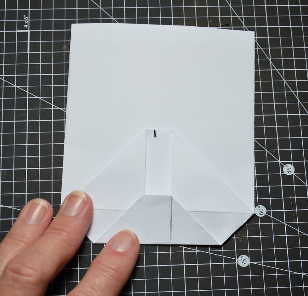 Fold bottom flap up so it is about 1cm above the centre fold line as shown.