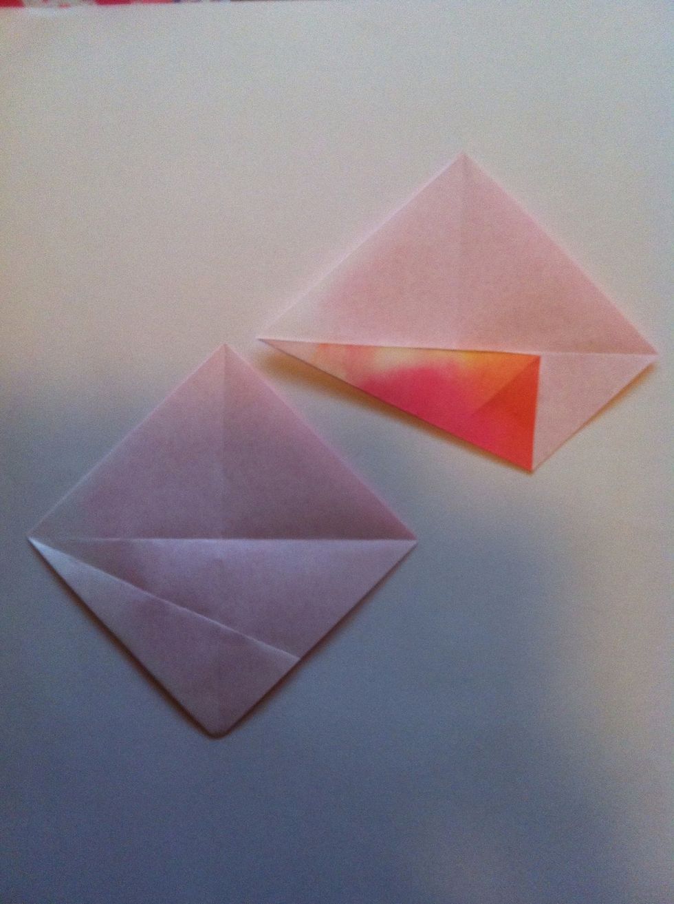 Fold bottom left side up to center crease.