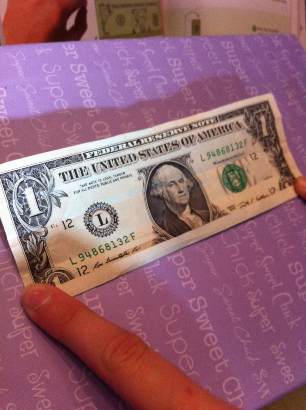 Fold bottom of the dollar bill to the middle of the one
