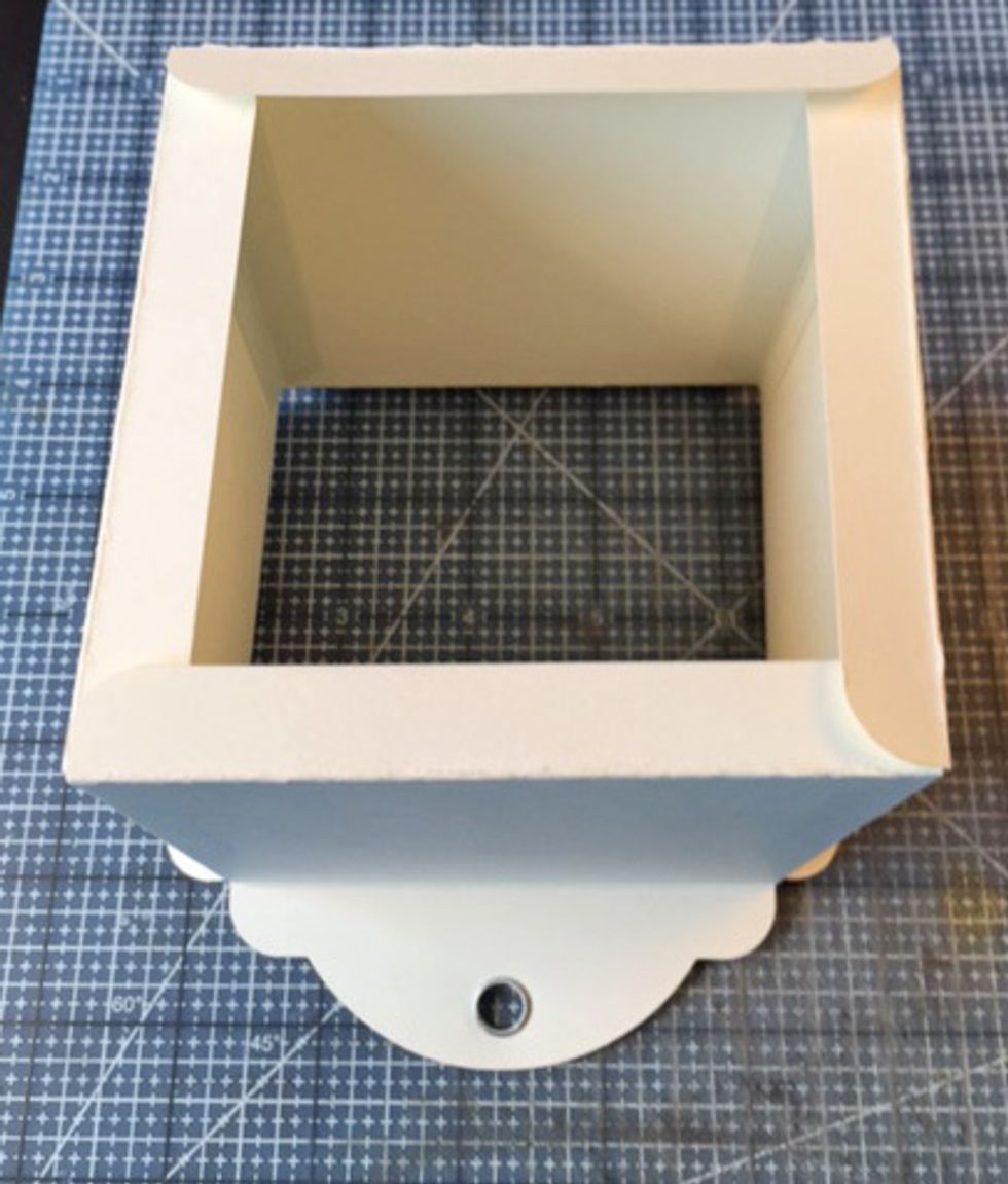 Fold bottom tabs towards center of box.