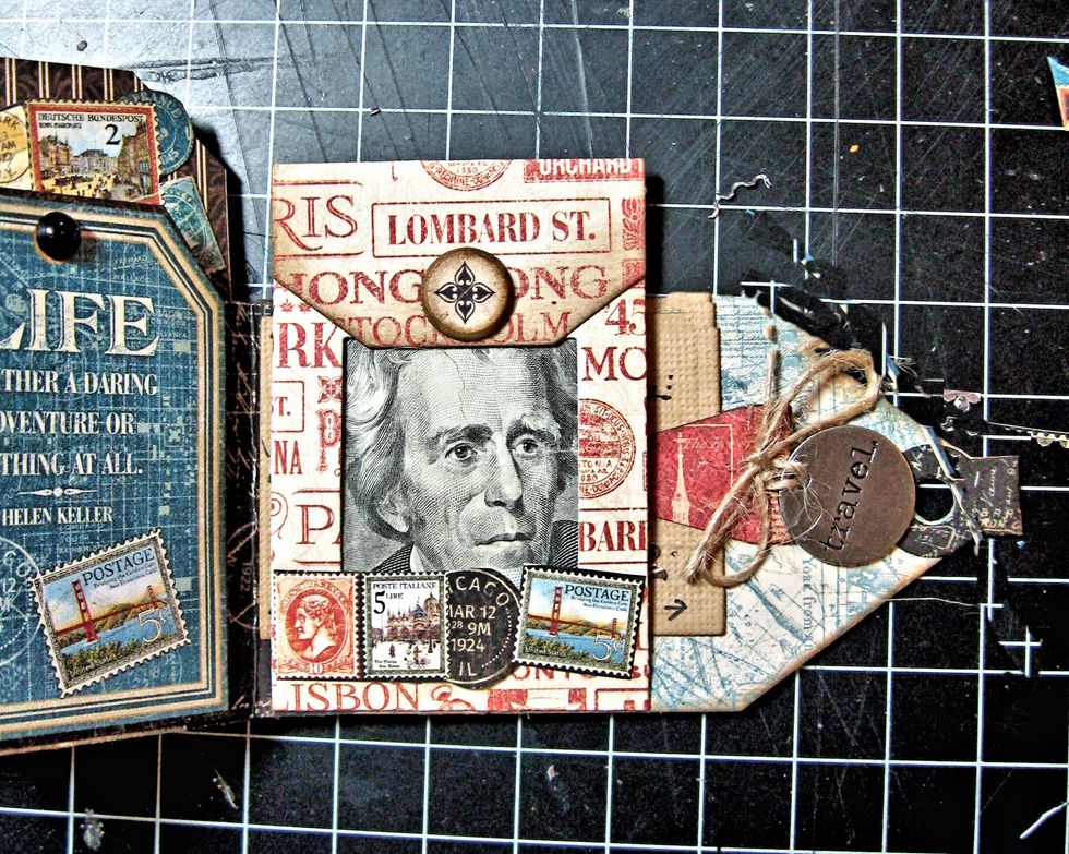 Fold cash and insert in envelope. Add fussy cut stamps and chipboard circle to envelope. Tuck mini postcard behind the envelope.