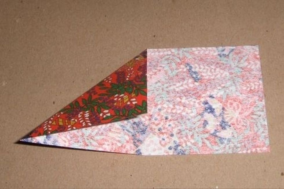 Fold corner down to center fold and crease. Unfold.