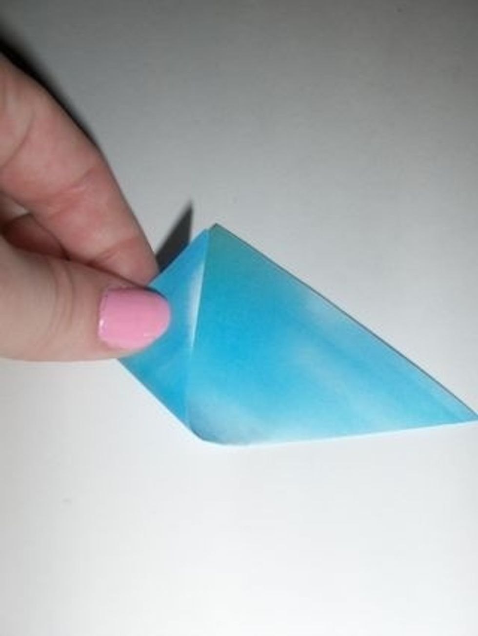 Fold corners in to center to form a diamond.