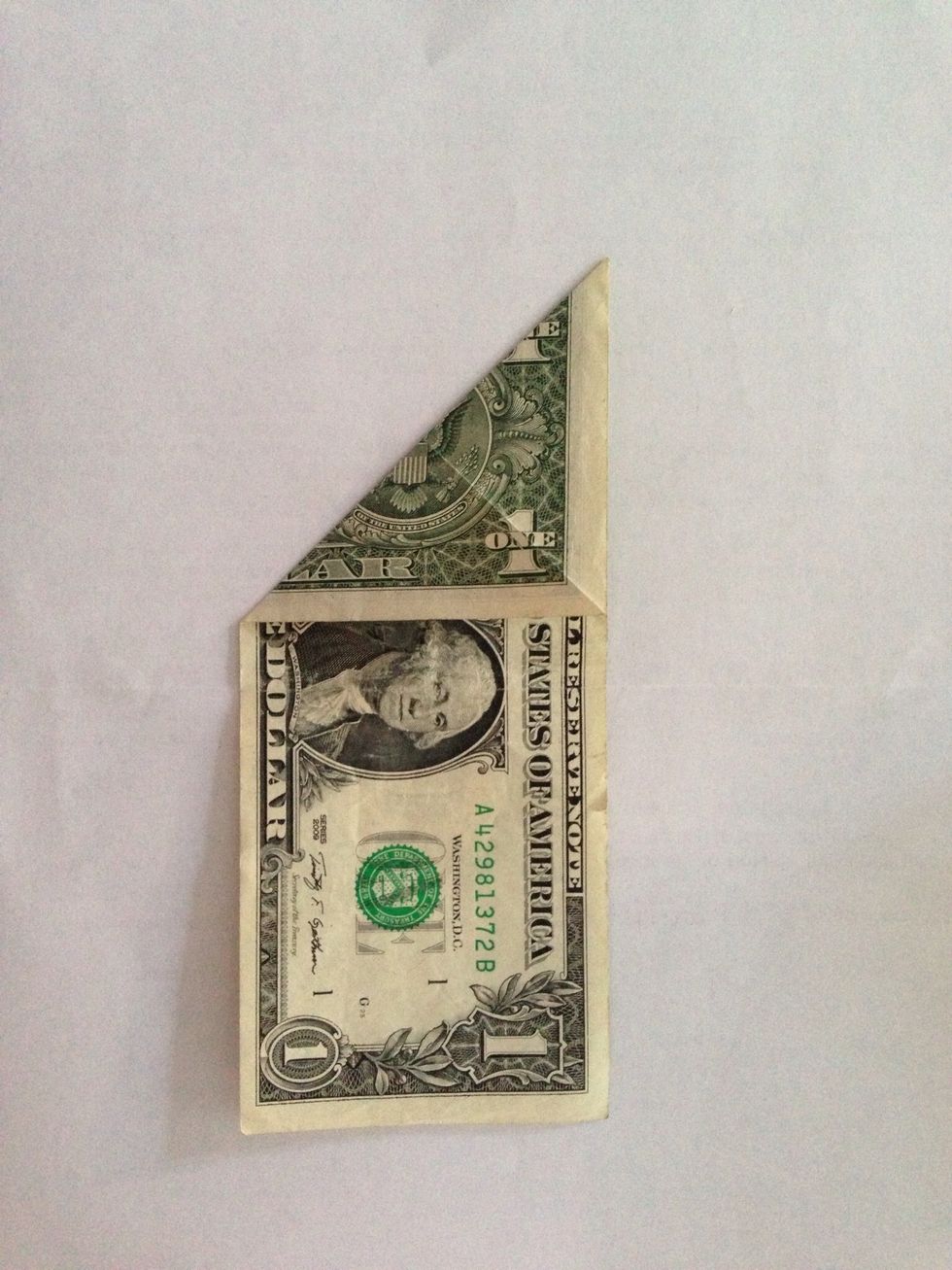 Fold diagonally again in other direction.