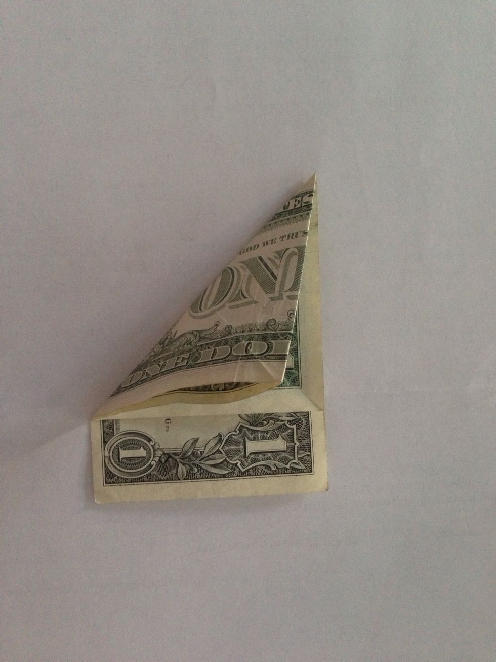 Fold diagonally again in other direction.