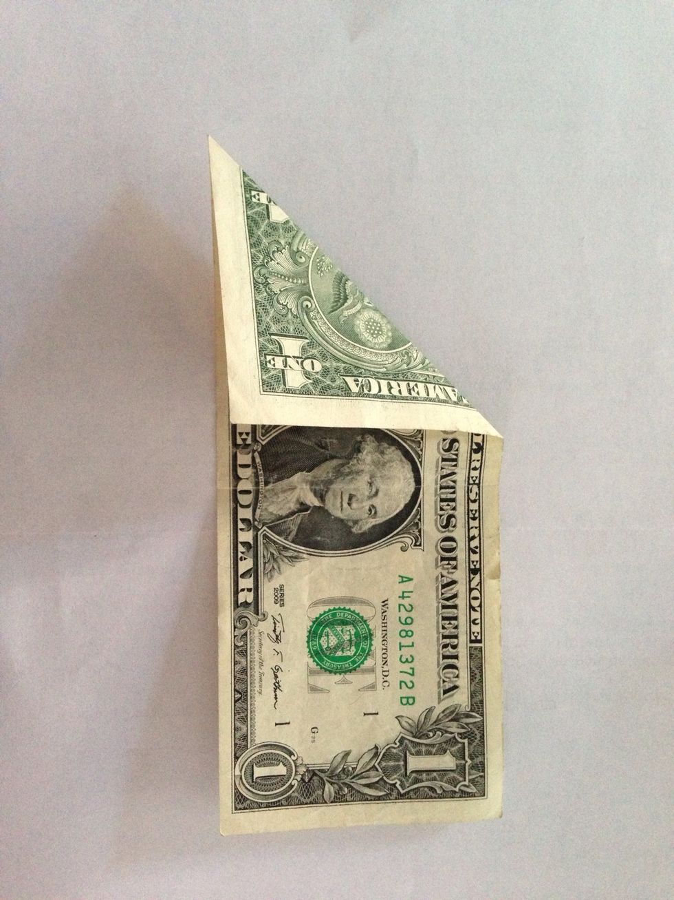 Fold diagonally, doesn't matter which side.