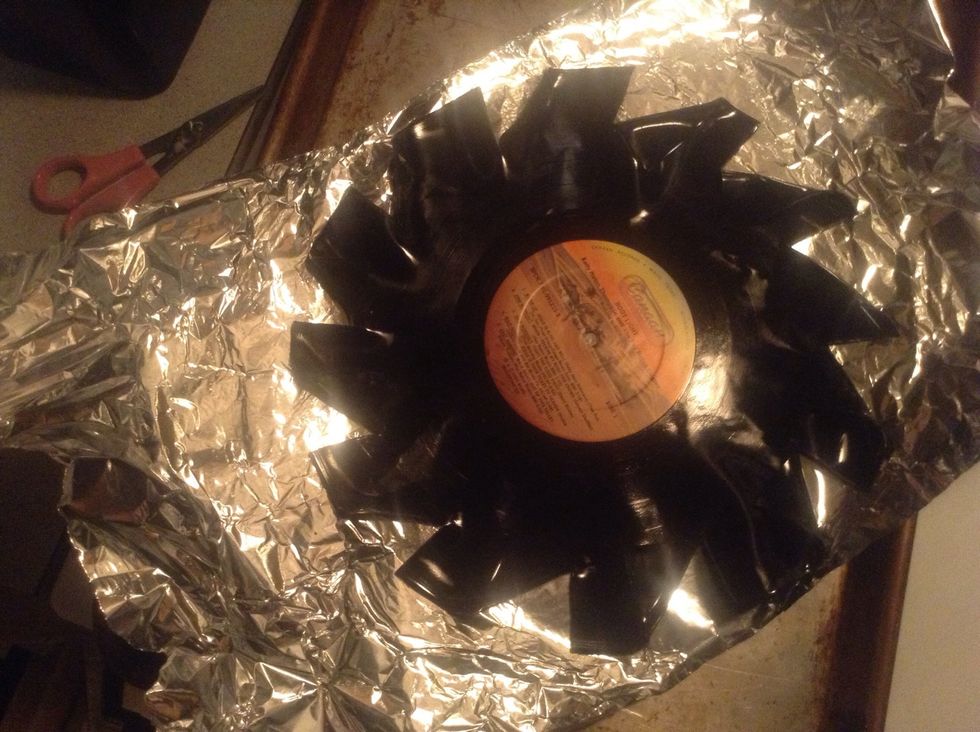 Fold down one edge of where the cuts were made and let it cool. Try to go fast so you dont have to reheat. If you attempt to reheat, the folds youve already made will come undone.