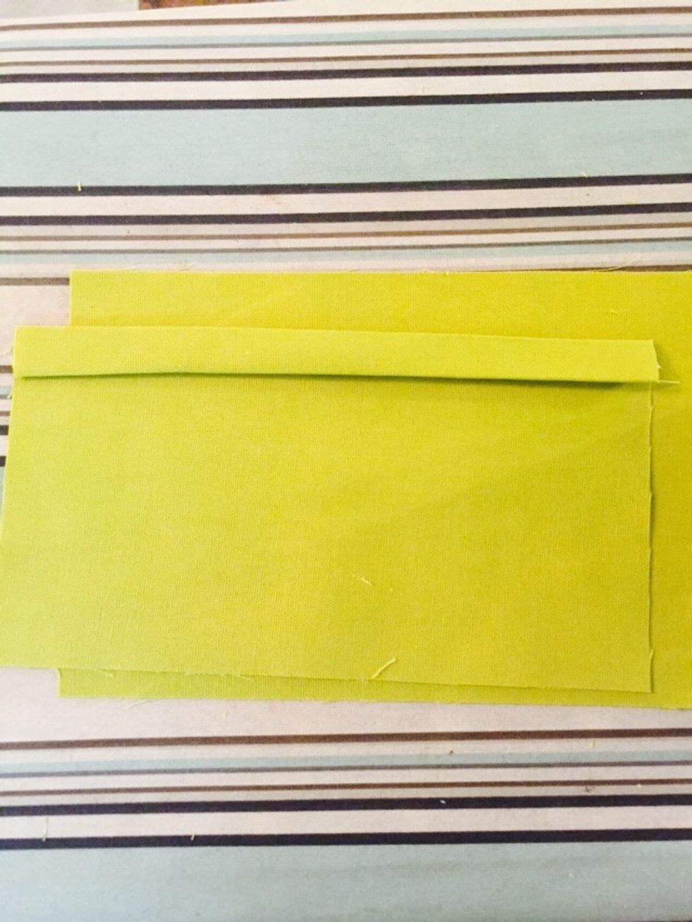 Fold down one side of the pocket about 1/2 an inch and press.