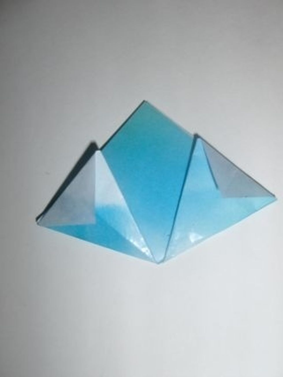 Fold down the corners sticking out as shown.
