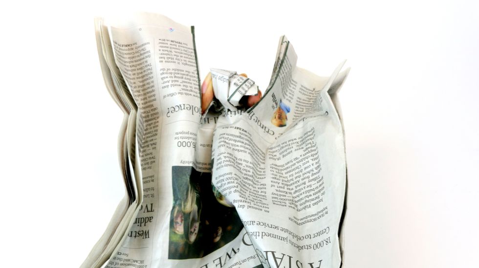 Fold down the middle flap at the top to form the head of your figurine.