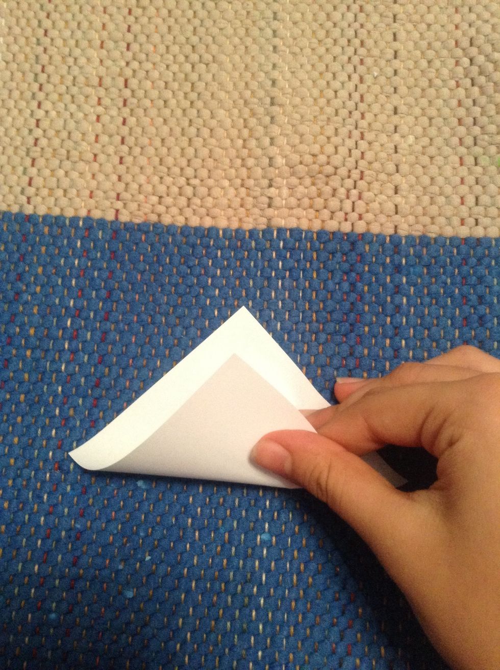 Fold down the squared paper into a triangle shape.