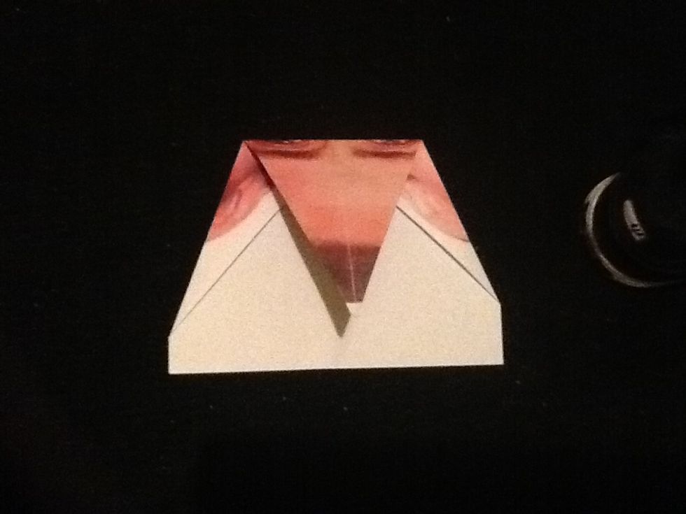 Fold down the tip so it touches the bottom of the paper