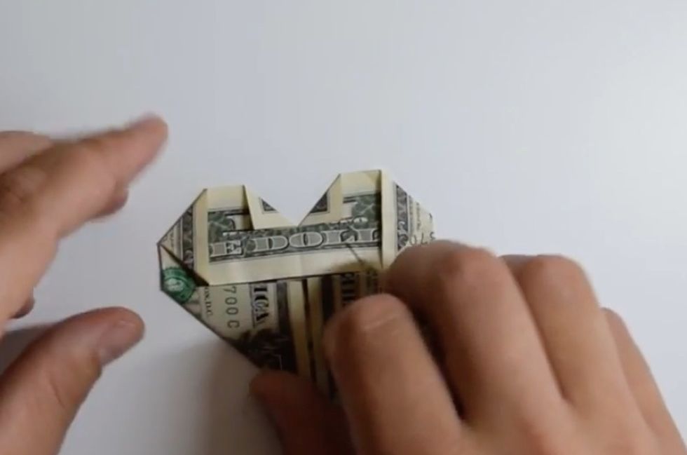 Fold down the triangles on the right and left of the bill