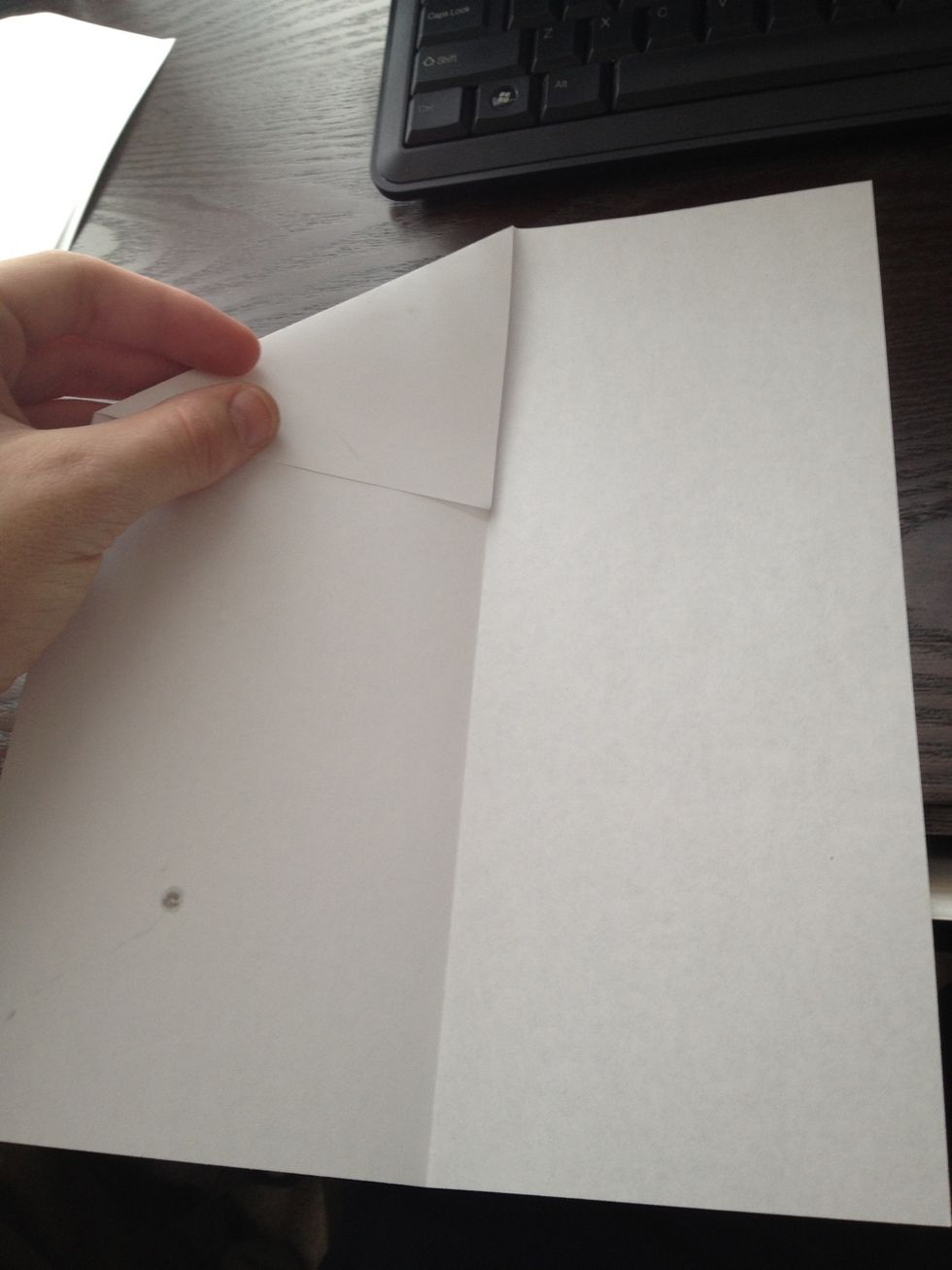 Fold down top edges to the midline so you get 2 right triangles at the top
