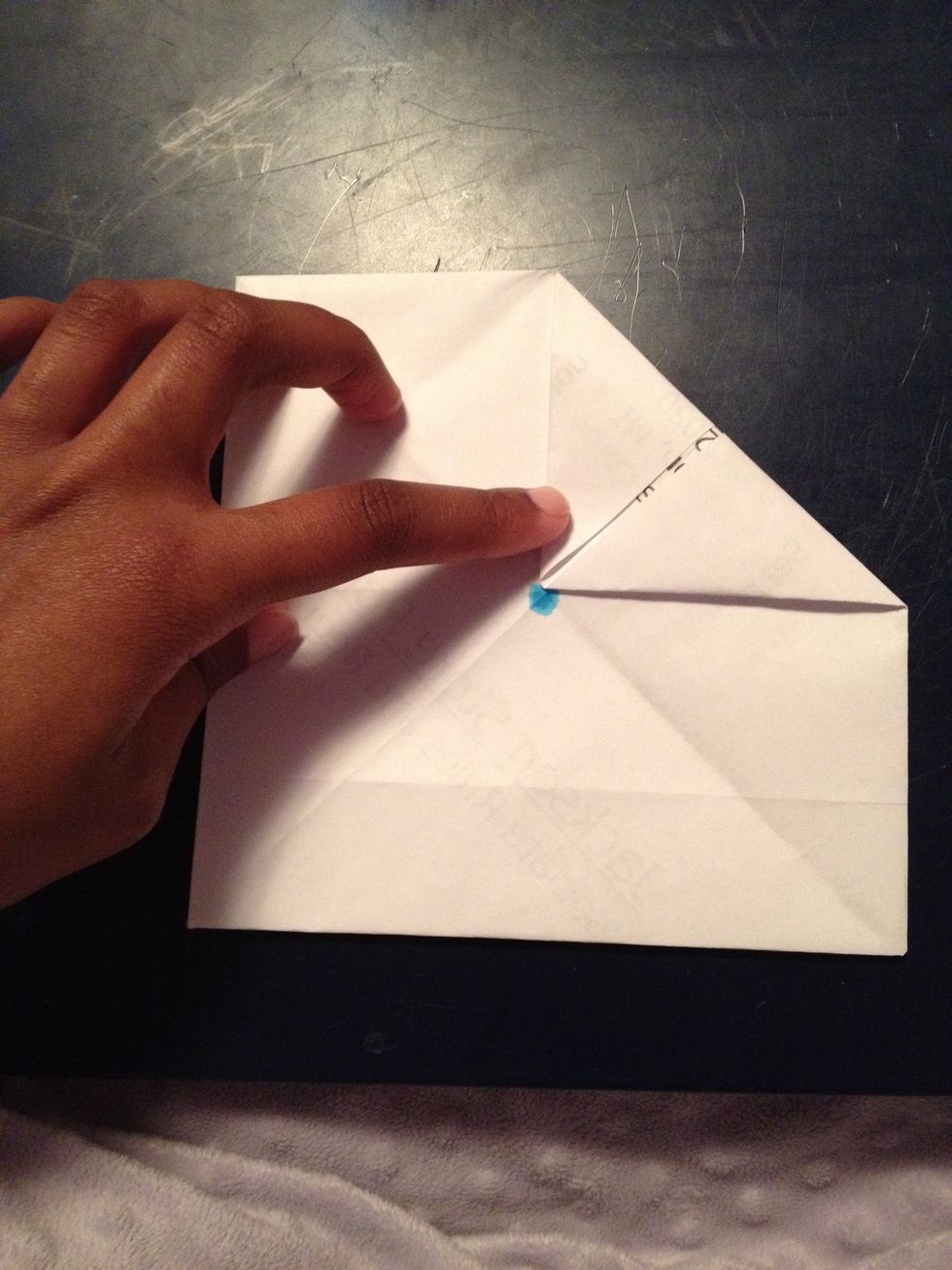 Fold each corner in so that it touches the middle (you can use a dot it you want).