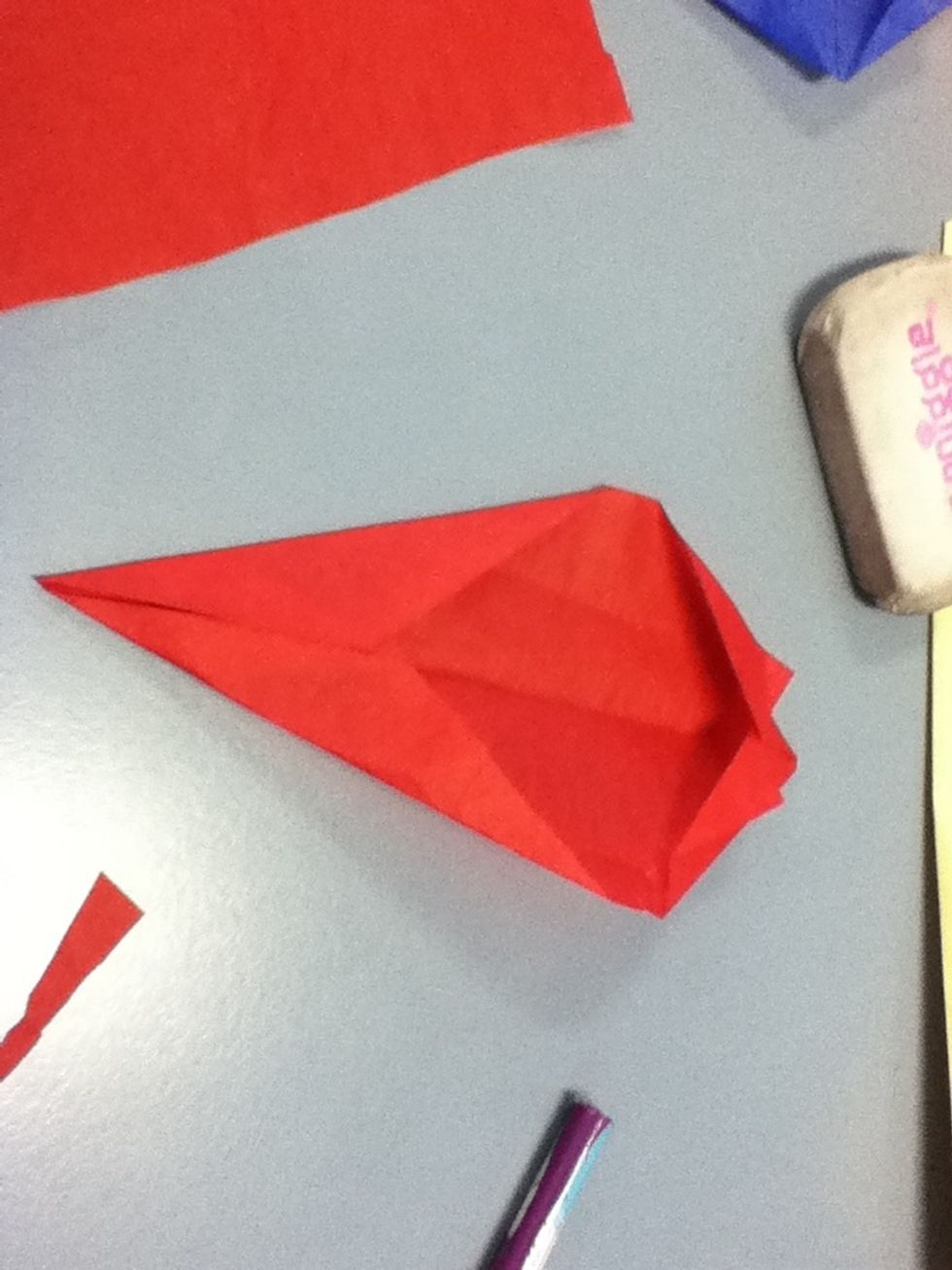 Fold each of the corners to meet the centre line.