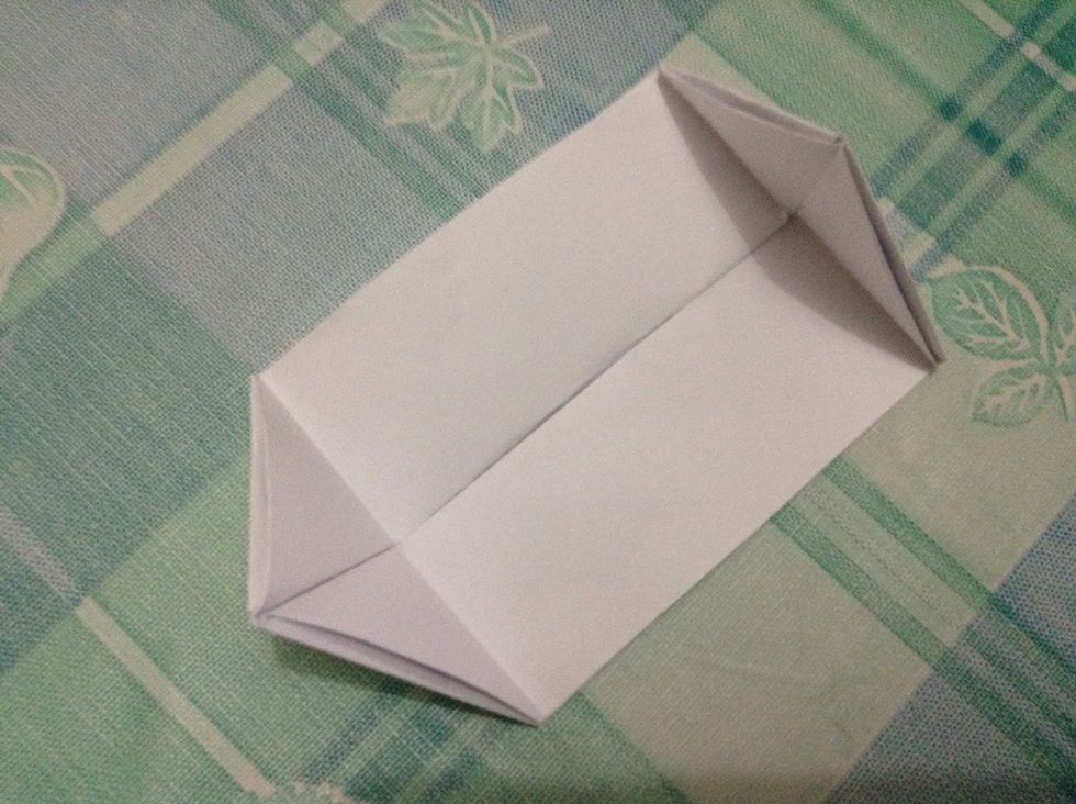 Fold each pointed end inward to create a triangular shape.