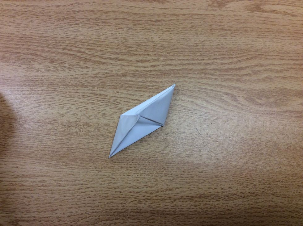 Fold each square at the top diagonally then fold towards the middle to make a parallelogram