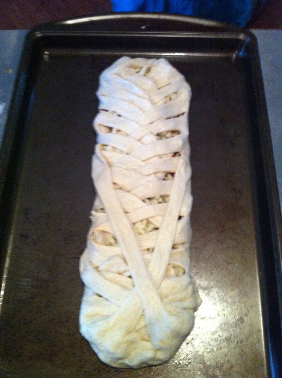 Fold each strip diagonally over the other... You can get as creative as you like here just make sure the majority of your toppings are covered.